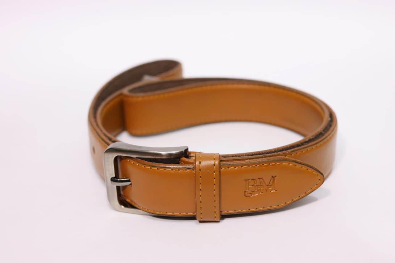 Brown leather belt with silver buckle on a white background