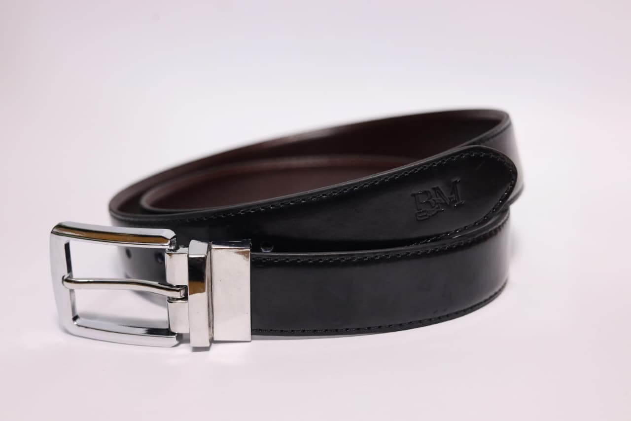 Black leather belt with silver buckle on a white background