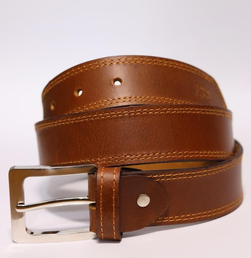 Brown leather belt with a silver buckle on a white background