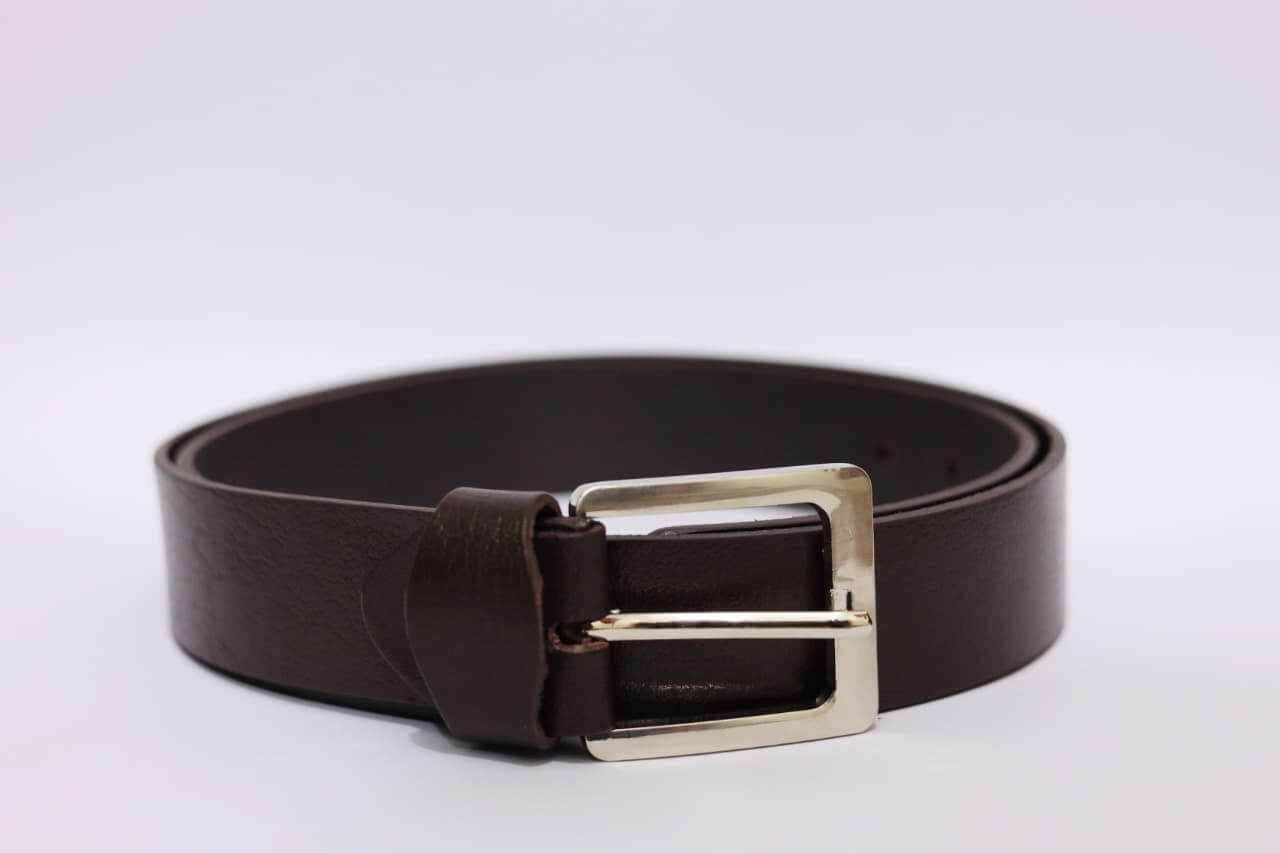 Brown leather belt with a silver buckle on a light gray background
