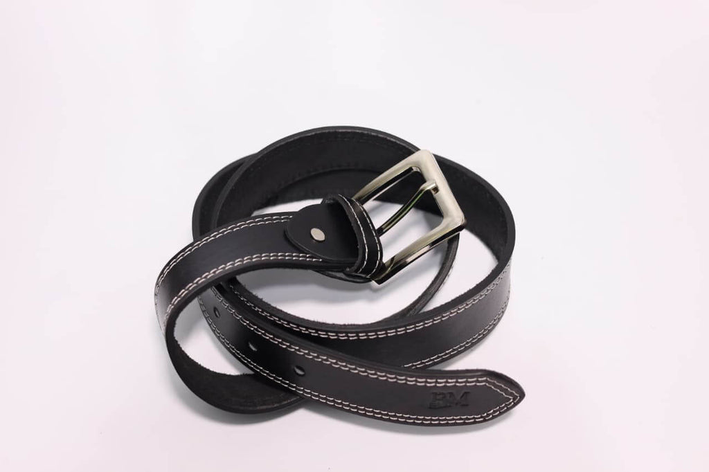 Black leather belt with silver buckle on a light gray background
