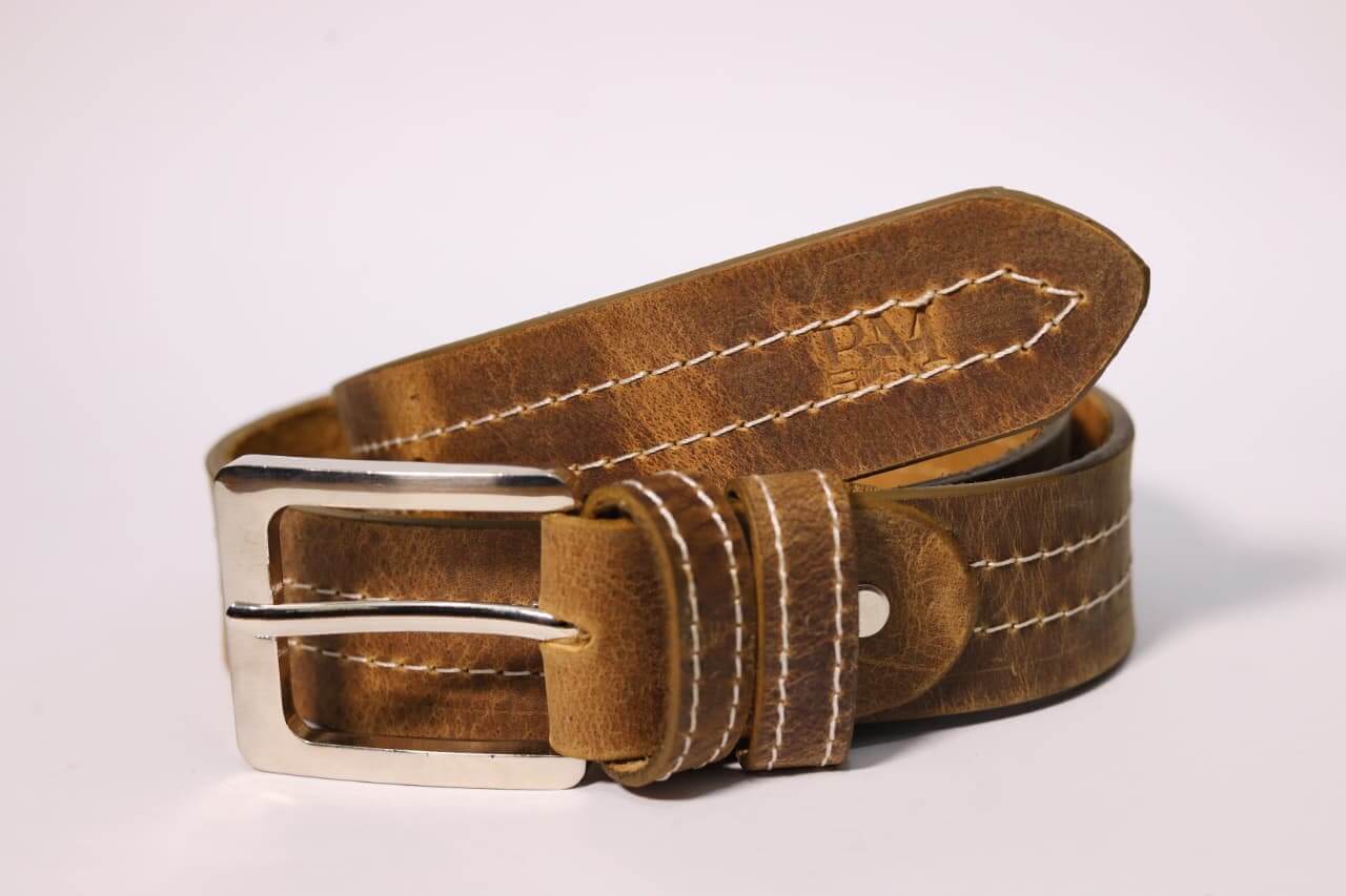 Brown leather belt with silver buckle on a white background